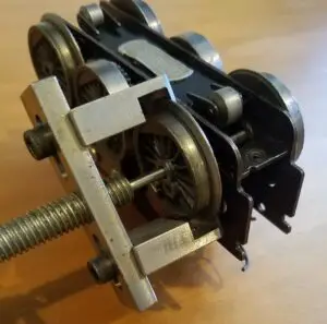 A typical Lionel Hudson, Praire or Adriatic engines. Pull wheel with gear on back first off the axle then you can pull the wheel and axle out to pull other wheel off.